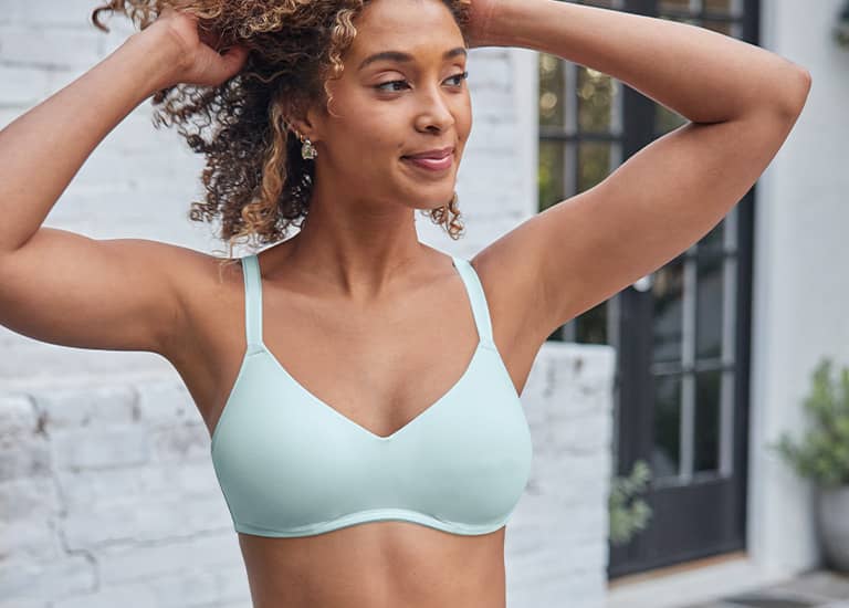 woman looking in a mirror wearing a Green Jockey sports bra