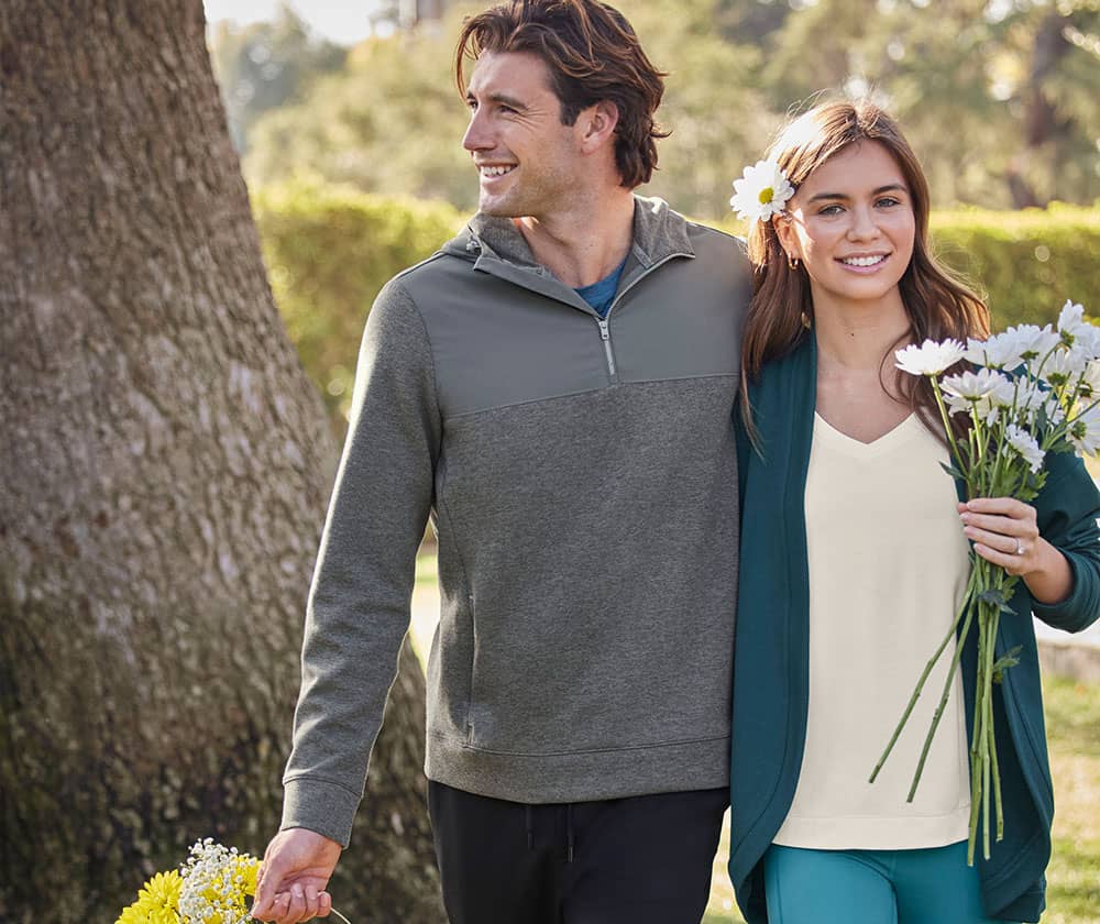 man and woman walking together in spring layers