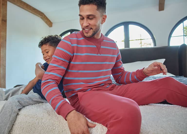 man relaxing in jockey plaid sleep pants and shirt