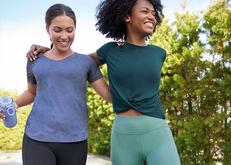 2 women walking outside together