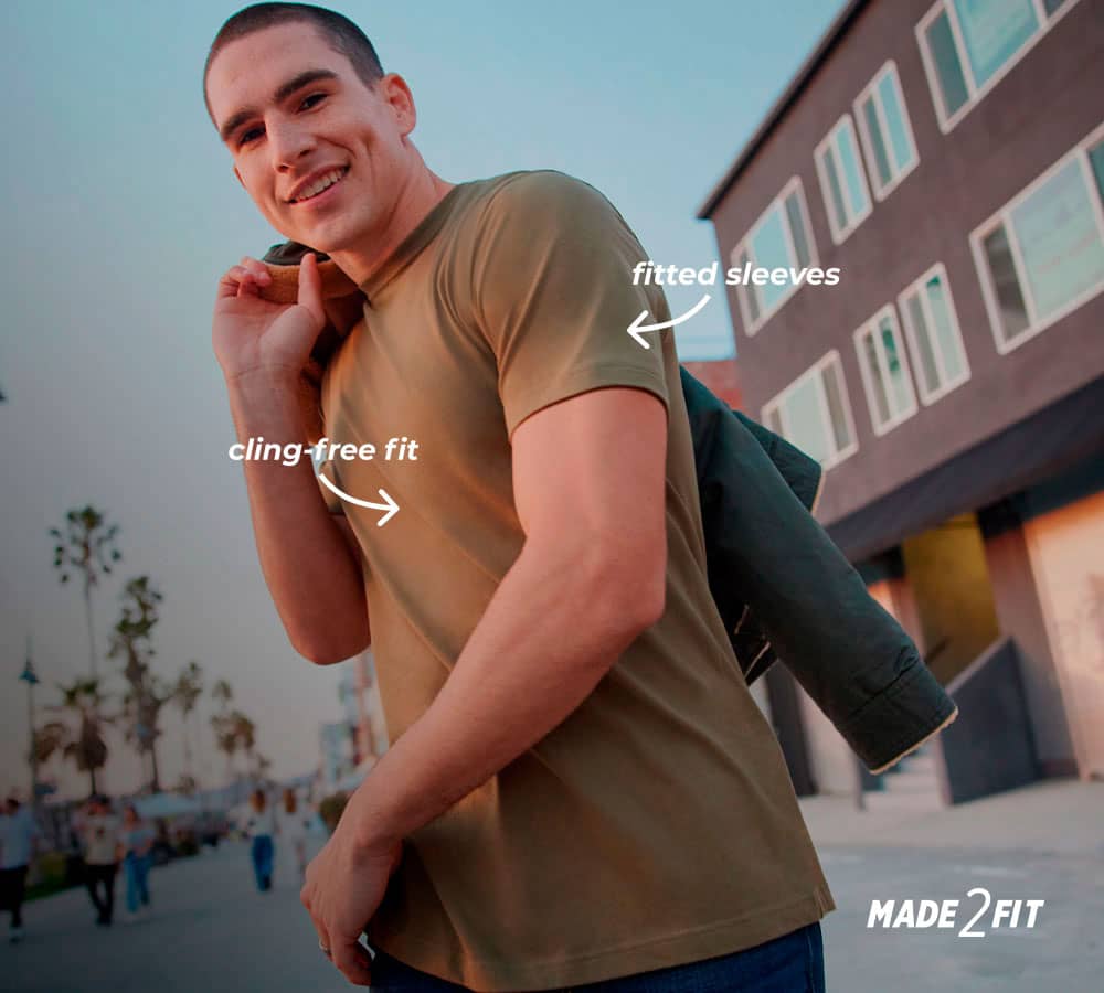 man wearing a new shirt outside showing off his arms