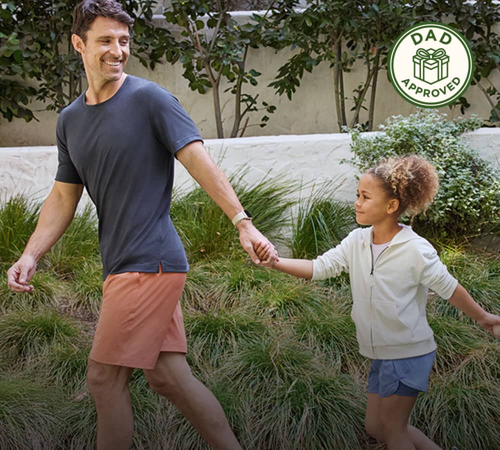 Father holding hand with child outdoors