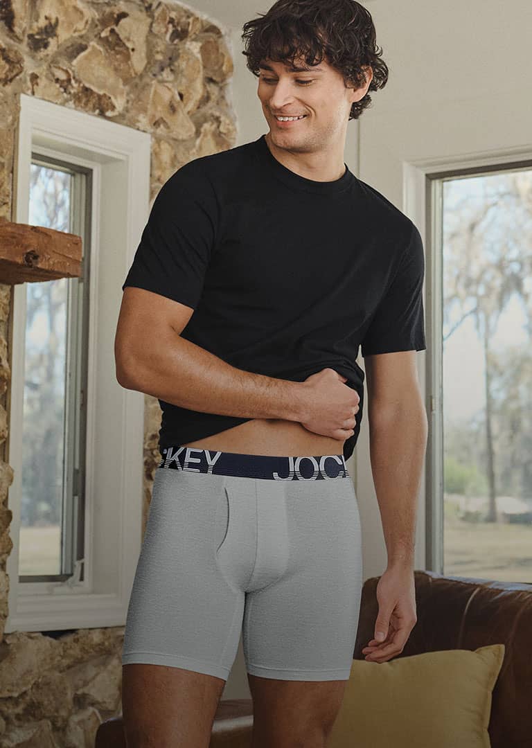 Man wearing a black tshirt and underwear inside
