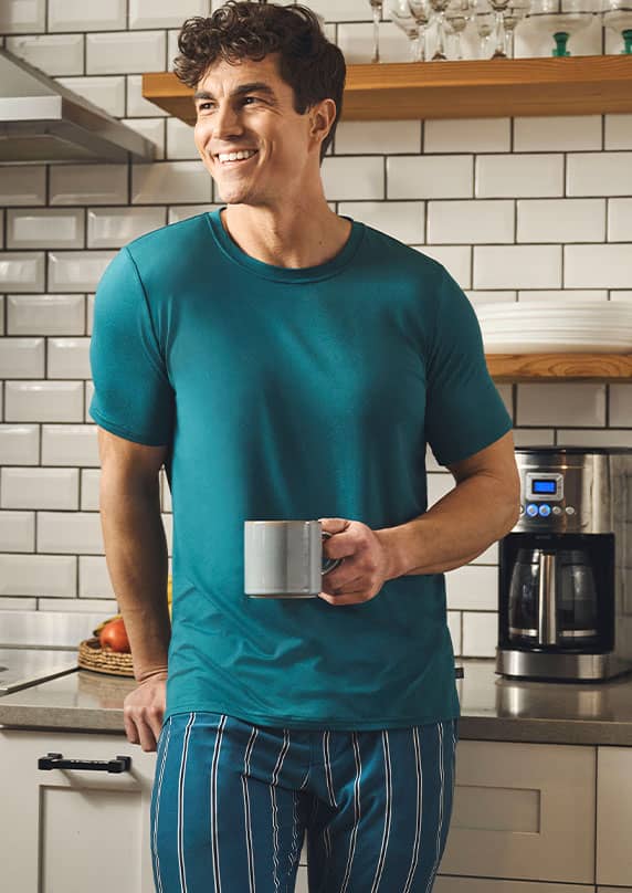 man drinking coffee in his green sleepwear